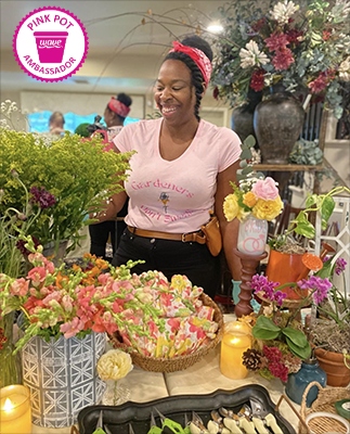 Woman creating a bouquet with various flower blooms