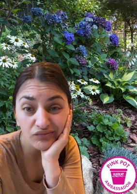 Woman with a questioning look with colorful flowers in the background