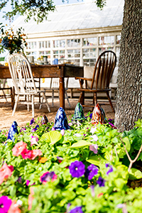 Outdoor table setting in a garden with mushroom decor