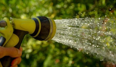 Water coming out of a yellow gardening hose