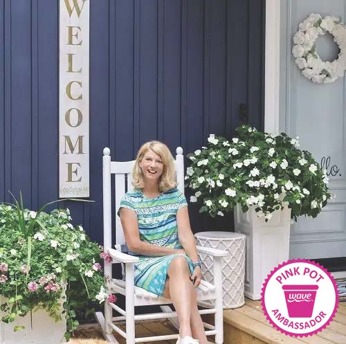 Wave Pink Pot Ambassador for June 2022 Janice outside among her flowers at her lake house