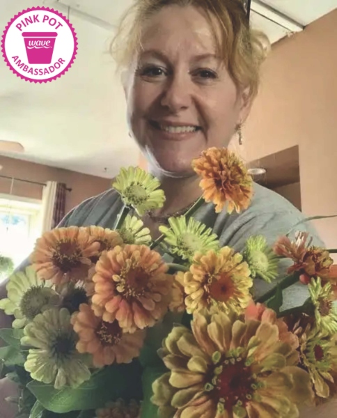 Woman holding a bouquet of green and orange flowers