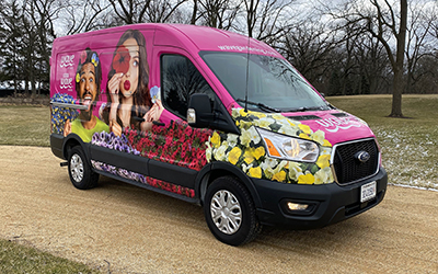 A bright pink sprinter van with Wave petunias.