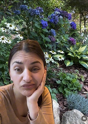 Woman with a questioning look with flowers in the background