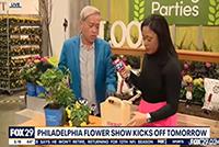 Tu Bloom and newscaster at the Philly Flower Show