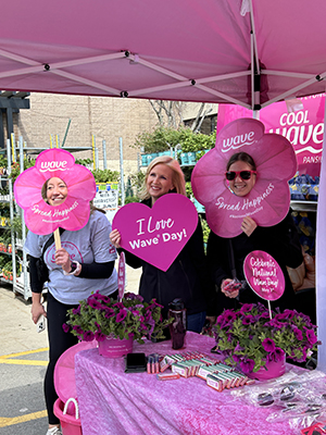 Three ladies in pink and celebrating National Wave Day